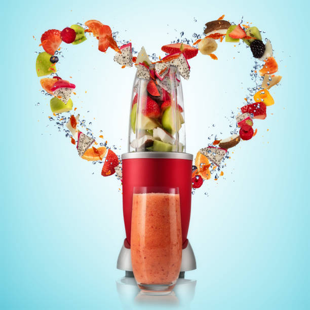 istock Smoothie mixer with drink and fruit flying ingredients in heart shape 929787250