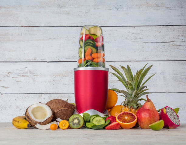 istock Smoothie maker mixer with pieces of fruit ingredients 929787326