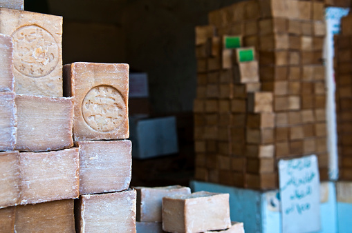 Aleppo, Syria - June 27, 2010: A downtown store selling soap handmade with olive oil and lye. The soap is one of the most well known products of Aleppo. Two of the bars in this photograph display the imprint of the factory that made it.