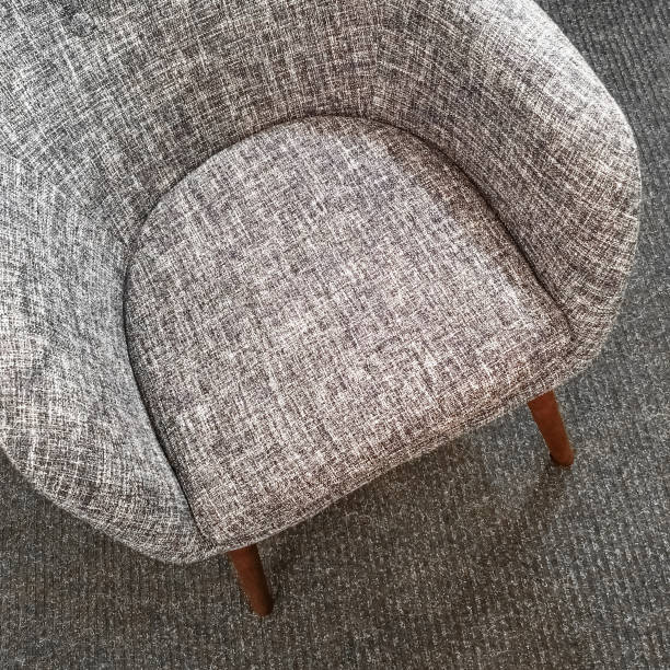 istock Stylish gray armchair on carpet floor 929790358