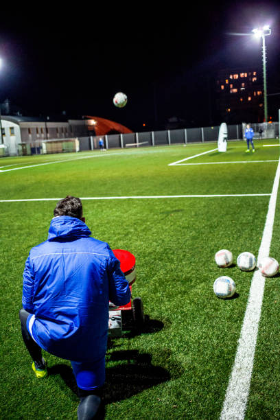 istock Goalkeepers Coach Using Soccar Ball Cannon at Training 929790426