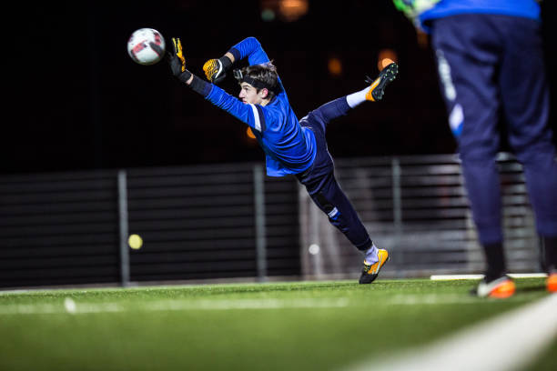 istock Goalkeeper Catching the Ball in Mid Air 929790436