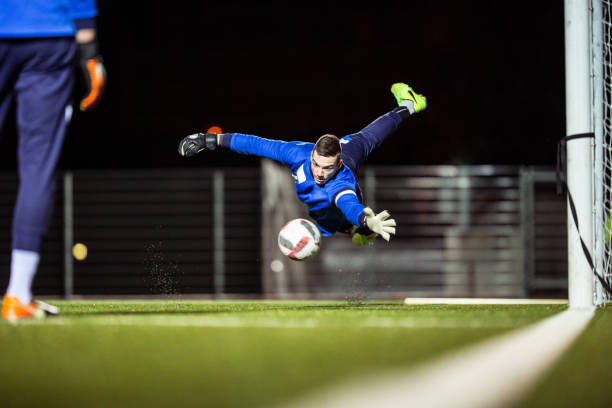 istock Goalkeeper Catching the Ball in Mid Air 929790438