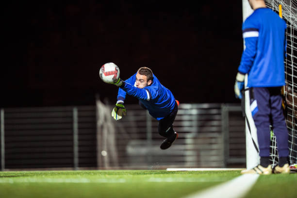 istock Goalkeeper Catching the Ball in Mid Air 929790460