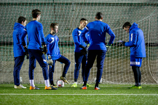 avoir une discussion avec l’entraîneur sur la formation de gardiens de but - goalie soccer soccer player teenage boys photos et images de collection