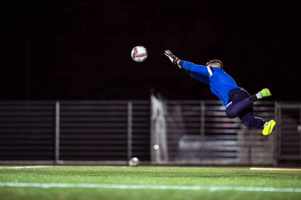 istock Goalkeeper Catching the Ball in Mid Air 929790472