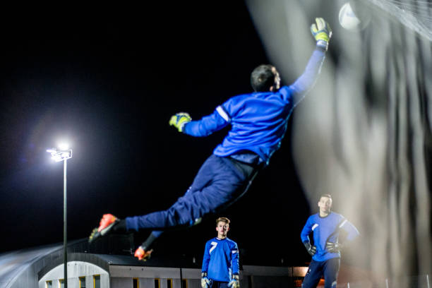 istock Goalkeeper Catching the Ball in Mid Air 929790536