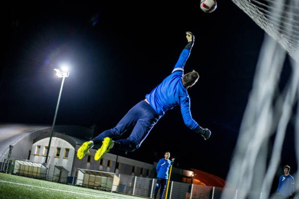 istock Goalkeeper Catching the Ball in Mid Air 929790544