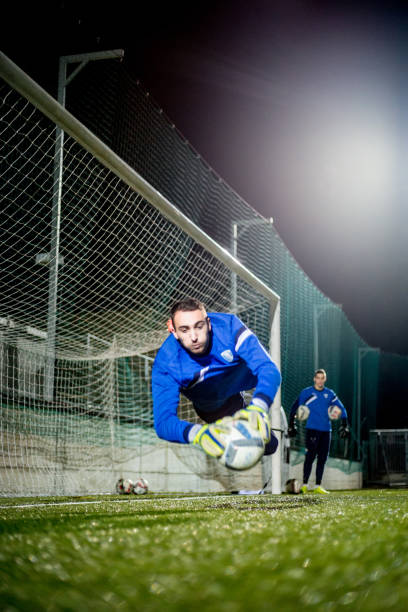 istock Goalkeeper Catching the Ball in Mid Air 929790550