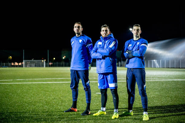 istock Goalkeepers and their Coach on Soccer Field 929790560