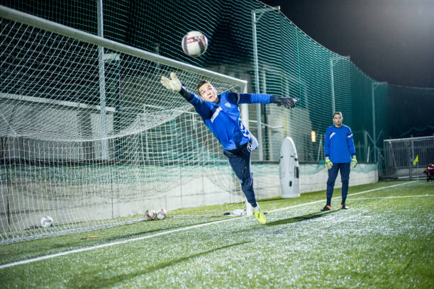istock Goalkeeper Catching the Ball in Mid Air 929790568