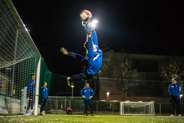 istock Goalkeeper Catching the Ball in Mid Air 929790576