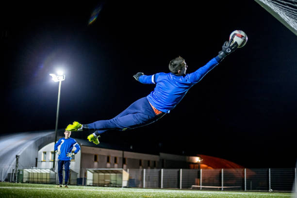 istock Goalkeeper Catching the Ball in Mid Air 929790590