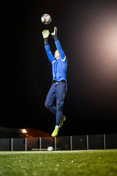 istock Goalkeeper Catching the Ball in Mid Air 929790600