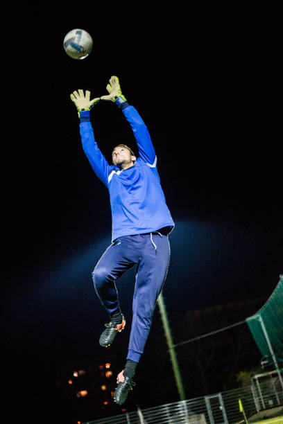 istock Goalkeeper Catching the Ball in Mid Air 929790610