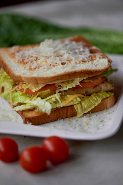 istock A delicious sandwich with salad and chicken. Sprinkled with cheese.A quick delicious Breakfast 929793616