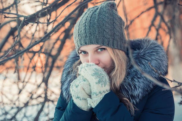 istock girl warms her hands in mittens 929793782