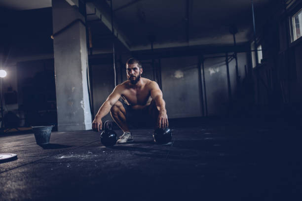 istock Bodybuilder workout with kettlebells in the gym 929796790