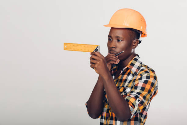 istock African-American builder uses measuring tape 929800528