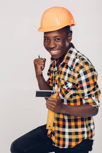 istock African-American builder uses measuring tape 929800776