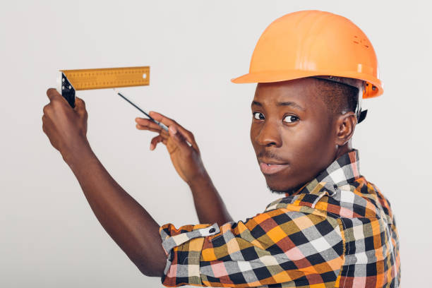 istock African-American builder uses measuring tape 929803188