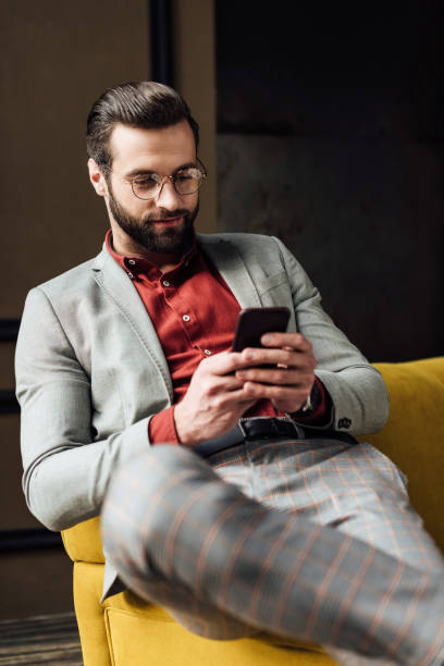 istock handsome stylish man in glasses using smartphone 929803964