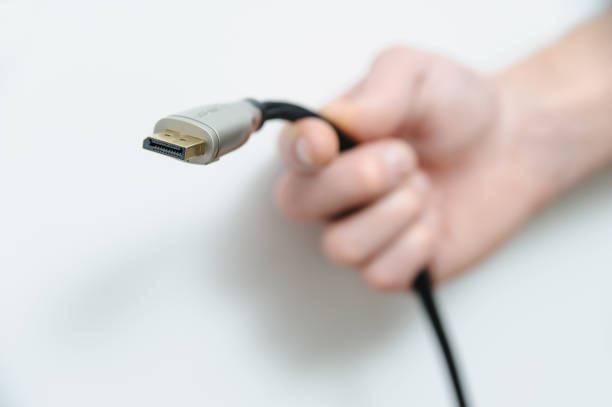 Cable plug DisplayPort. The hand of man is holding the cable plug DisplayPort. connection block computer cable electronics industry electricity stock pictures, royalty-free photos & images