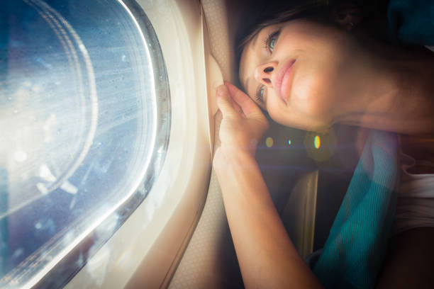istock Happy, female airplane passanger enjoying the view from the cabon window 929806436