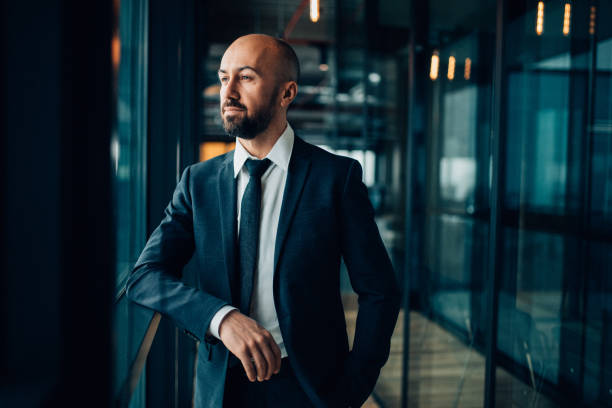 istock Thoughtful businessman standing at office passage 929818272