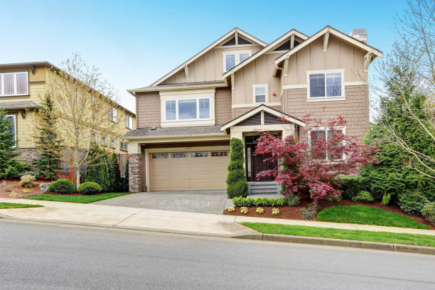 istock Lovely beige home exterior with well kept front yard. 929819566