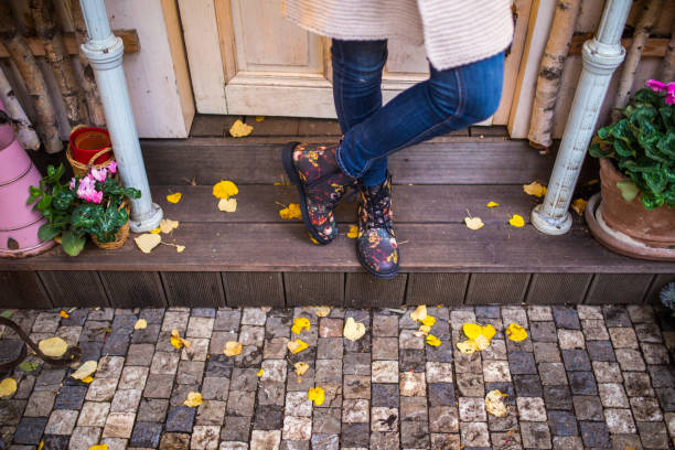 Close-up Of Person Walking In Boots On Street
