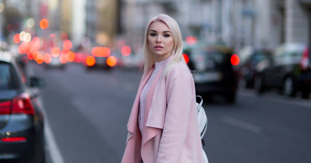 istock Young woman with backpack walking on the european streets 929855842