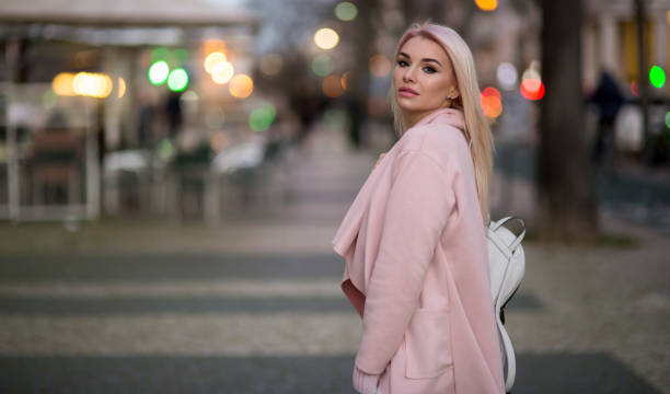 istock Young woman with backpack walking on the european streets 929855866