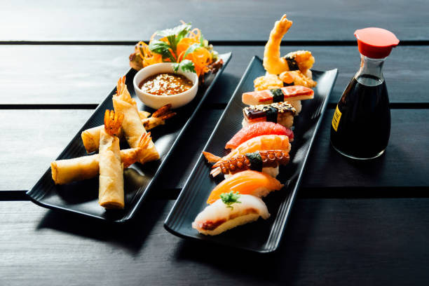 istock Sushi Set sashimi and sushi rolls served on stone slate 929861310