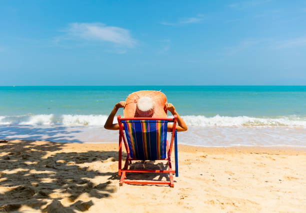 istock Woman in beach chair 929868700