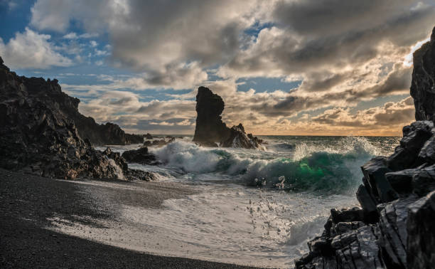 istock Sun Illuminates Crashing Waves against Sea Stacks on Iceland Beach 929872914