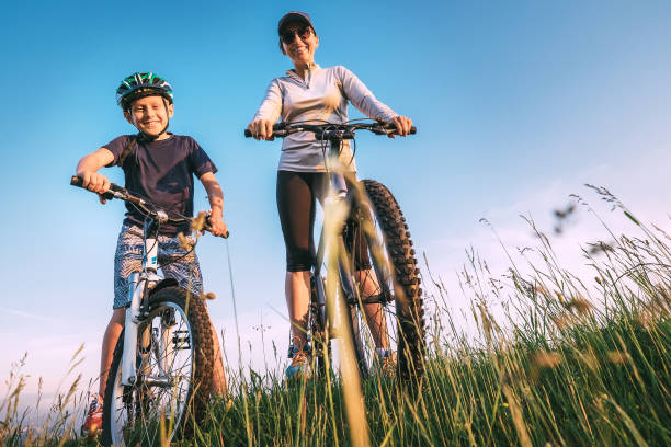 Mother and start to ride a bicykles