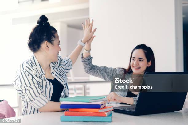 Students Women Teamwork Hjgh Five Together Working Study Online Or Homework Success Project With Laptop Computer And Meeting In University Campus Indoor Stock Photo - Download Image Now