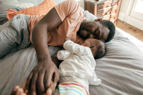 Happy father playing with toddler son