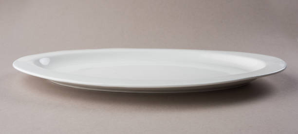 istock Empty white long and oval ceramic plate isolated on white or gray background 929884322