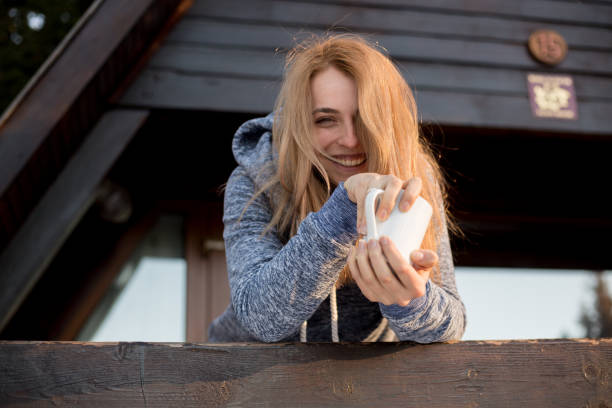 istock beauty woman drink coffee outside 929884656