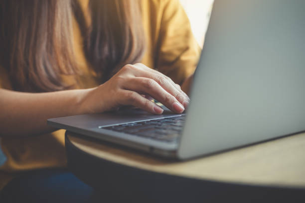 istock Closeup image of woman's hands working and typing on laptop keyboard on wooden table 929888134