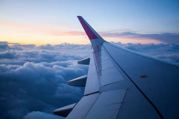 istock Morning sunrise with Wing of an airplane. 929891030