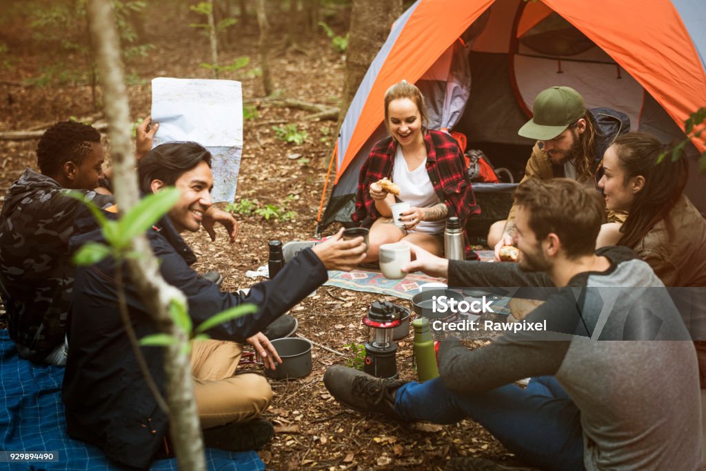 Friends camping in the forest together Camping Stock Photo