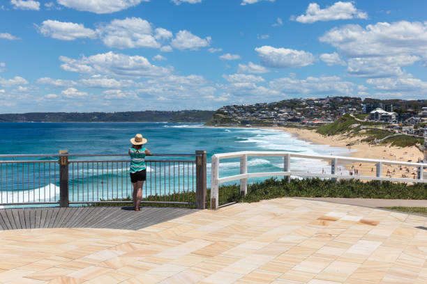 Bar Beach - Newcastle Australia - Woman enjoying the view A woman enjoys the view of Bar beach - Merewether in Newcastle Australia. Bather's way is a newly developed coast walk in Australia's second oldest city a few hours drive north from Sydney. newcastle australia stock pictures, royalty-free photos & images