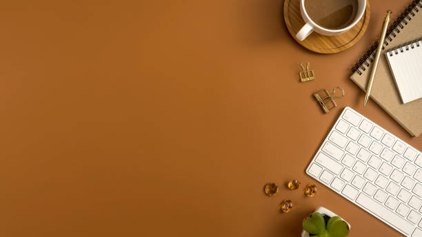 istock Styled stock photography brown office desk table with blank notebook, computer, supplies and coffee cup. Top view with copy space. Flat lay. 929898256