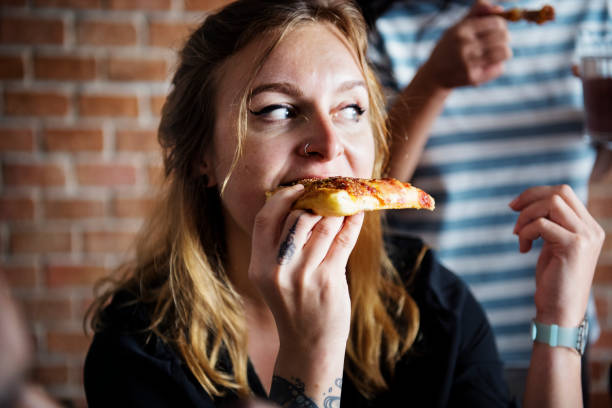 istock Friends eating pizza together at home 929898376