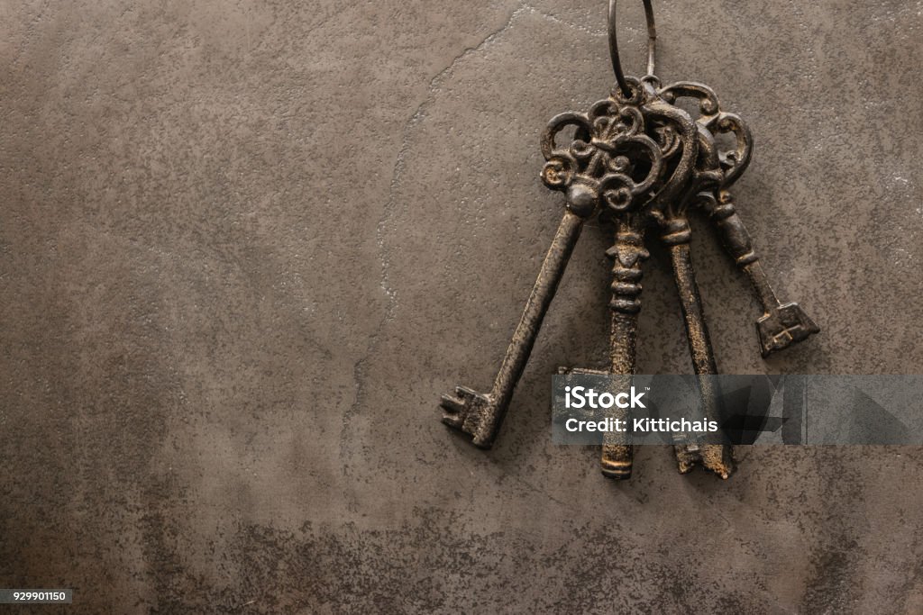 antique keys on old steel metal texture background Key Stock Photo