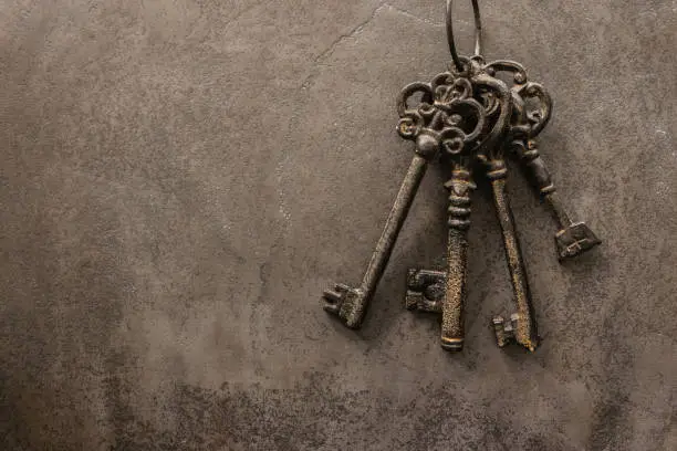 Photo of antique keys on old steel metal texture background