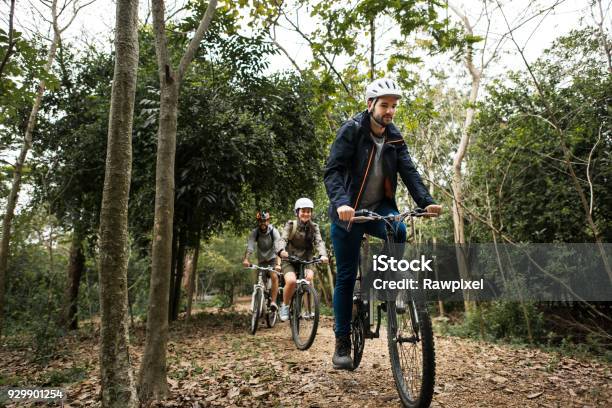 Group Of Friends Ride Mountain Bike In The Forest Together Stock Photo - Download Image Now